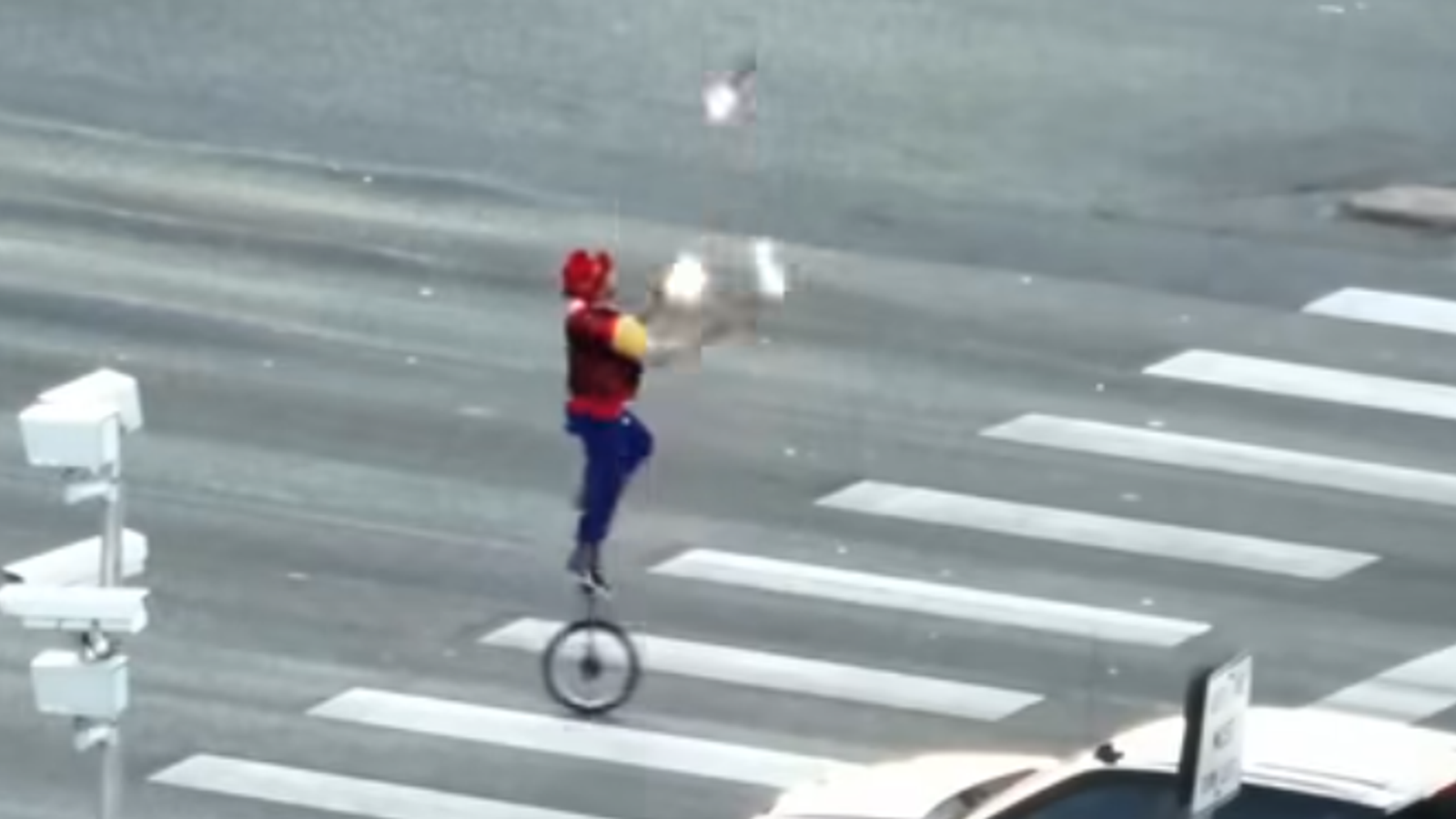 Fire-juggling unicyclist caught performing on crossing